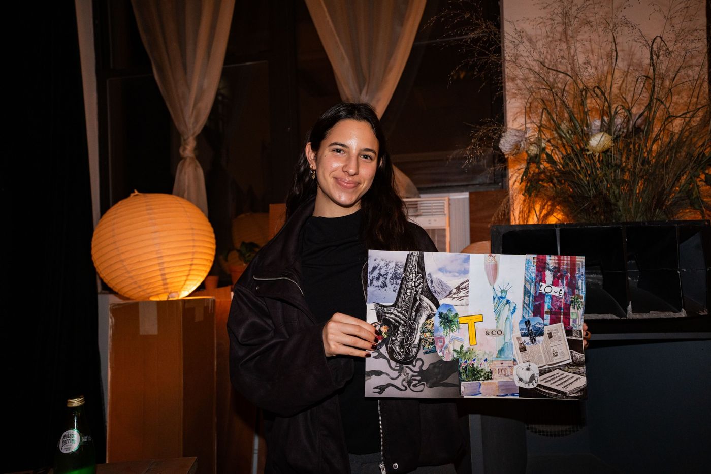 A guest holding up the finished piece she made in honor of someone she lost.